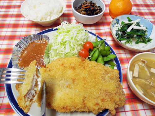 お皿からはみ出す、超特大チキンカツです！ガーリックの下味で食欲が増します。小鉢もばっちり！